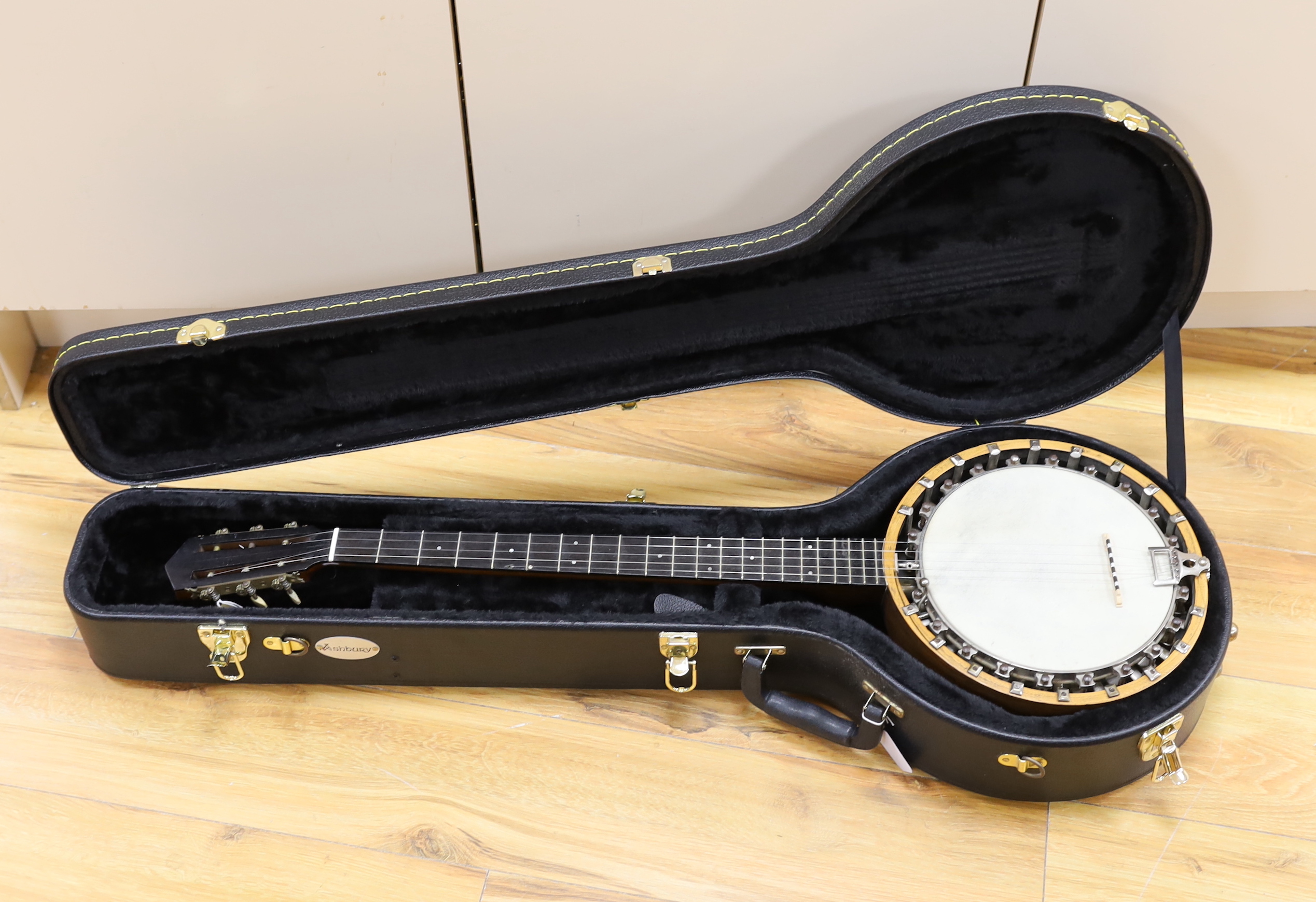 A six string banjo, unmarked, in a hard case by Ashbury